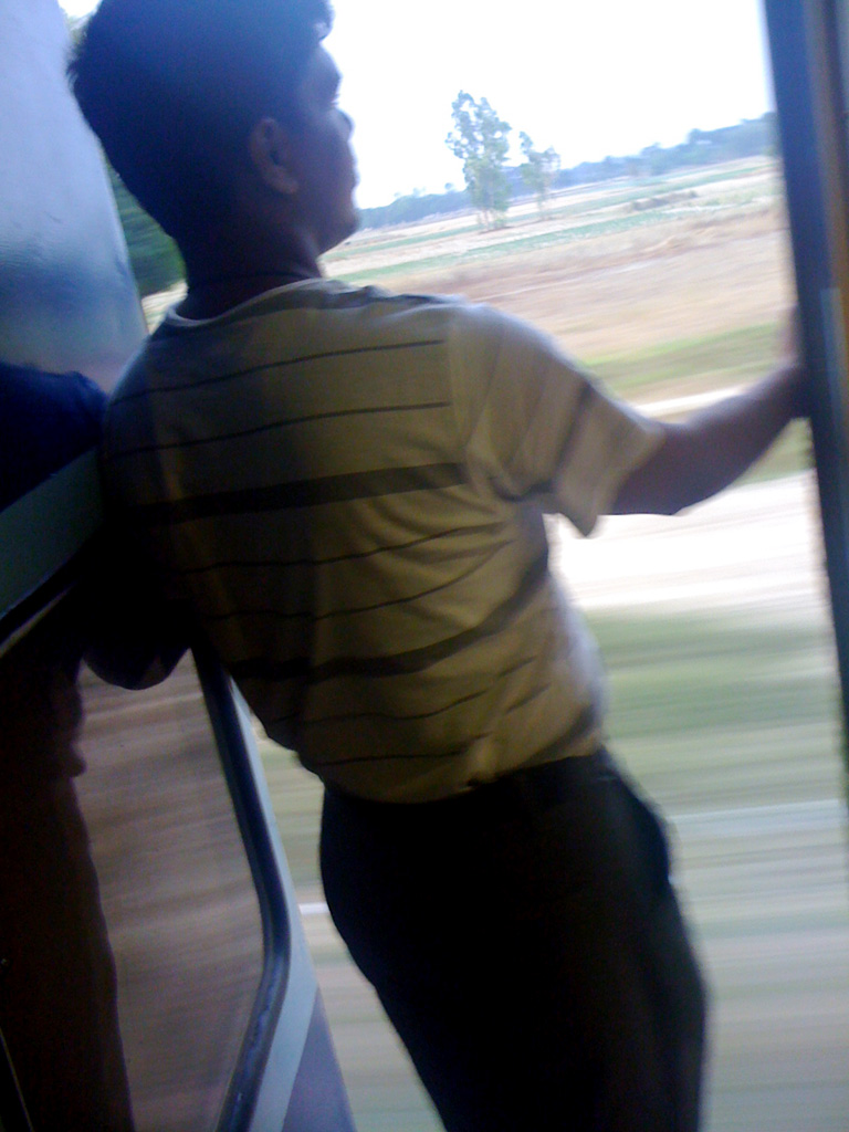 インドの長距離列車のドアの前に立つ男